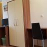 Möglichkeit zum Arbeiten, © Haus Nova Ein einfacher Raum mit Schreibtisch, Stuhl, Kleiderschrank und kleinem Fernseher.